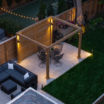 Modern Cedar Pergola, Porcelain Patio & Outdoor Lighting Backyard Renovation
