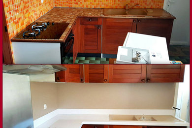 Idée de décoration pour une cuisine design fermée avec un plan de travail en quartz et une crédence en ardoise.