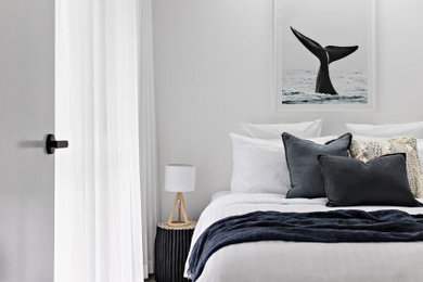 This is an example of a beach style bedroom in Wollongong.