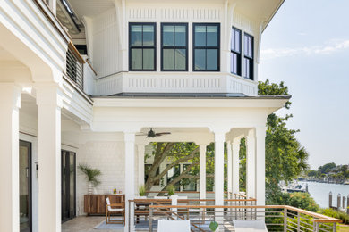 Example of a beach style home design design in Charleston