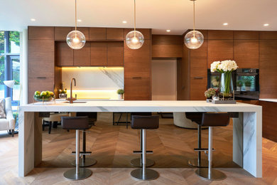 This is an example of a large modern l-shaped open plan kitchen in Other with a double-bowl sink, flat-panel cabinets, brown cabinets, quartz worktops, white splashback, ceramic splashback, black appliances, light hardwood flooring, an island, beige floors and white worktops.