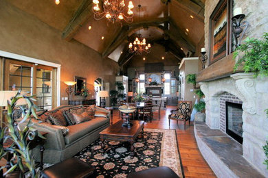 Living room - mid-sized rustic open concept medium tone wood floor living room idea in Other with brown walls, a standard fireplace and a brick fireplace
