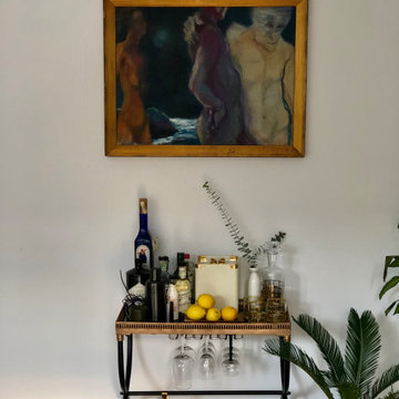A dramatic painting by a local artist plays backdrop for the home bar