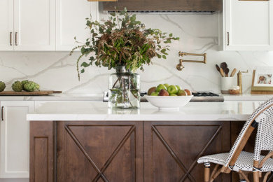 Eat-in kitchen - large farmhouse galley eat-in kitchen idea in Los Angeles with a farmhouse sink, recessed-panel cabinets, white cabinets, quartz countertops, quartz backsplash, stainless steel appliances, an island and white countertops