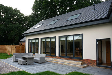 Design ideas for a medium sized and multi-coloured modern two floor house exterior in Buckinghamshire with mixed cladding, a pitched roof and a tiled roof.
