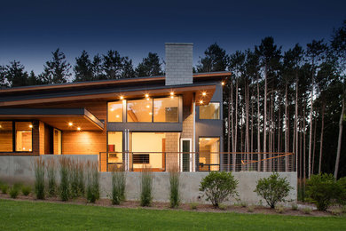 Photo of a contemporary two-storey exterior with wood siding and a shed roof.