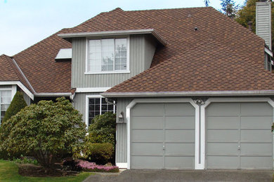 This is an example of a mid-sized transitional two-storey grey exterior in Seattle with wood siding, a hip roof and a shingle roof.