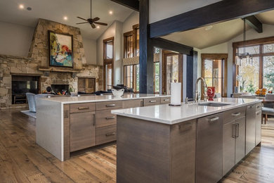 This is an example of a mid-sized contemporary l-shaped eat-in kitchen in Salt Lake City with an undermount sink, flat-panel cabinets, dark wood cabinets, quartz benchtops, grey splashback, ceramic splashback, stainless steel appliances, dark hardwood floors, multiple islands and brown floor.