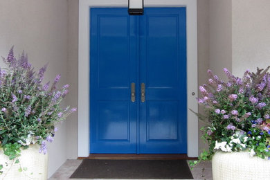 Inspiration for a mid-sized transitional beige stucco exterior home remodel in New York