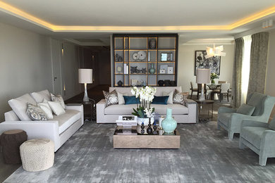 Photo of a transitional family room in Other with beige walls and medium hardwood floors.