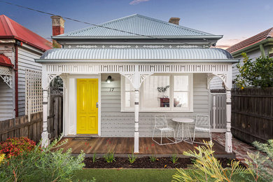 Inspiration for a contemporary front door in Melbourne with a single front door and a yellow front door.