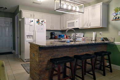 Example of a mid-sized country u-shaped kitchen design in Jacksonville with flat-panel cabinets and gray cabinets