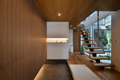 Modern entryway in Nagoya with porcelain floors and a single front door.