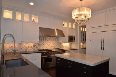 Open concept kitchen - mid-sized transitional l-shaped medium tone wood floor open concept kitchen idea in Chicago with an undermount sink, shaker cabinets, black cabinets, quartz countertops, blue backsplash, mosaic tile backsplash, stainless steel appliances and an island
