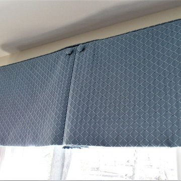 Box pleat valances enhanced with covered buttons in a quiet study