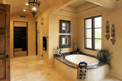 Large elegant master travertine floor and beige floor bathroom photo in San Diego with beige walls and a hinged shower door