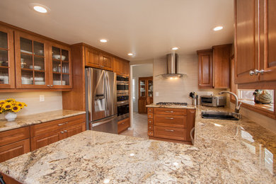 Kitchen - mid-sized transitional u-shaped ceramic tile kitchen idea in San Diego with a double-bowl sink, raised-panel cabinets, medium tone wood cabinets, solid surface countertops, white backsplash, ceramic backsplash, stainless steel appliances and a peninsula