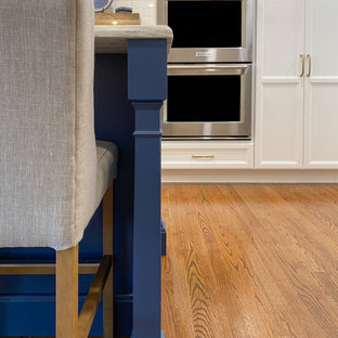 White and Blue Kitchen with Wood Hood