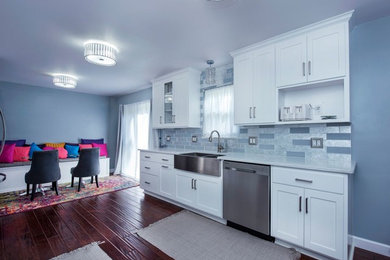 Mid-sized trendy galley dark wood floor and brown floor eat-in kitchen photo in Columbus with a farmhouse sink, shaker cabinets, white cabinets, granite countertops, multicolored backsplash, subway tile backsplash, stainless steel appliances, no island and white countertops