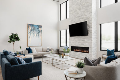 Large transitional open concept medium tone wood floor, gray floor and vaulted ceiling family room photo in Chicago with a ribbon fireplace, a stacked stone fireplace, a wall-mounted tv and brown walls