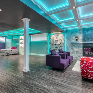Design ideas for an expansive classic fully buried basement in Toronto with grey walls, laminate floors, a standard fireplace and a stone fireplace surround.