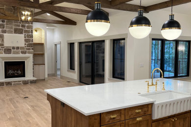 Inspiration for a large transitional l-shaped light wood floor and shiplap ceiling kitchen remodel in Other with a farmhouse sink, shaker cabinets, beige cabinets, quartz countertops, gray backsplash, marble backsplash, stainless steel appliances, an island and white countertops