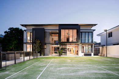 This is an example of a mid-sized contemporary two-storey white exterior in Brisbane with metal siding, a flat roof and a metal roof.