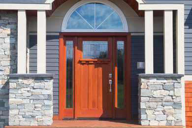Huge arts and crafts dark wood floor entryway photo in Burlington with gray walls and a medium wood front door
