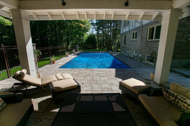 Inspiration for a large timeless backyard tile and rectangular pool remodel in Ottawa