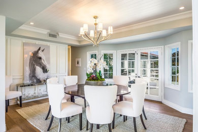 Mid-sized transitional medium tone wood floor and brown floor enclosed dining room photo in Los Angeles with gray walls