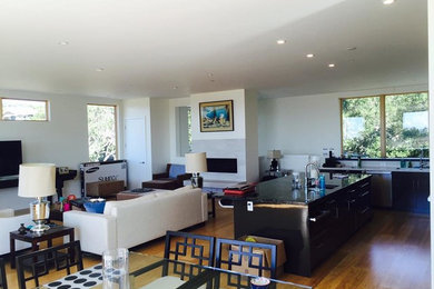 Inspiration for a mid-sized transitional l-shaped open concept kitchen remodel in Other with an undermount sink, flat-panel cabinets, dark wood cabinets, granite countertops and an island