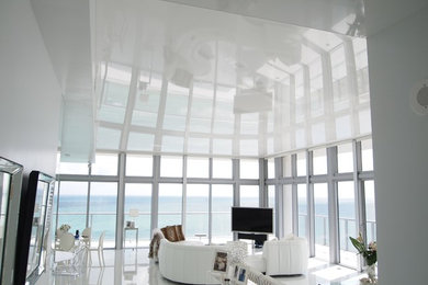 Game room - large modern open concept marble floor game room idea in Miami with white walls, no fireplace and a tv stand