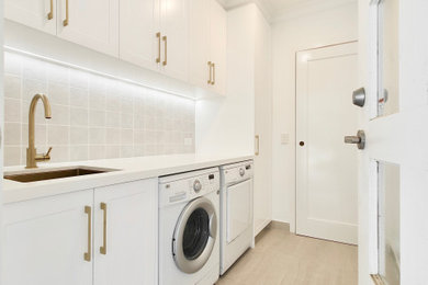 Beach style laundry room in Melbourne.