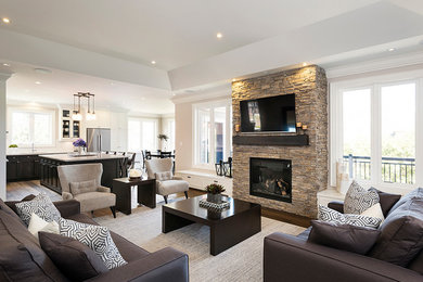 Design ideas for a large transitional formal open concept living room in Toronto with beige walls, dark hardwood floors, a standard fireplace, a stone fireplace surround and a wall-mounted tv.