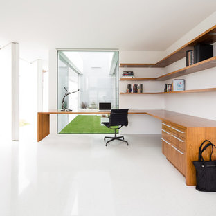 Design ideas for a medium sized modern study in Los Angeles with white walls, a built-in desk and white floors.