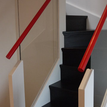 Glass staircase with red stainless steel handle