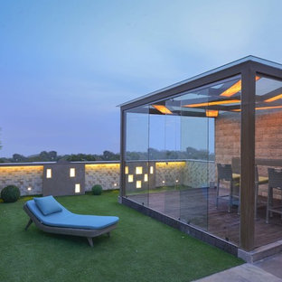 Mid-sized contemporary rooftop partial sun garden in Delhi with concrete pavers.