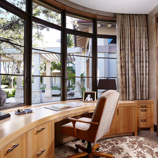 Immagine di un ufficio etnico di medie dimensioni con pareti beige, nessun camino, scrivania incassata, pavimento in cemento e pavimento marrone