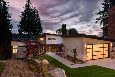 Inspiration for a contemporary beige three-story mixed siding house exterior remodel in Phoenix with a shed roof
