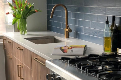 Inspiration for a mid-sized contemporary l-shaped ceramic tile and gray floor enclosed kitchen remodel in New York with an undermount sink, flat-panel cabinets, medium tone wood cabinets, quartz countertops, blue backsplash, ceramic backsplash, no island and multicolored countertops