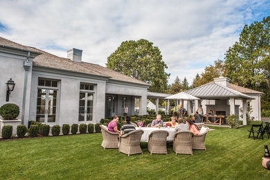 Mid-sized tuscan gray two-story stucco exterior home photo in Portland with a hip roof