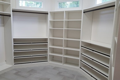 Large trendy walk-in closet photo in Charlotte with white cabinets