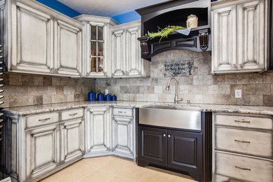 L-shaped kitchen photo in Other with a farmhouse sink, granite countertops, multicolored backsplash, cement tile backsplash and multicolored countertops