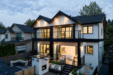 Inspiration for a mid-sized contemporary backyard ground level metal railing deck remodel in Vancouver with a fireplace and no cover