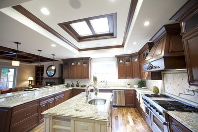 Example of a large u-shaped medium tone wood floor and brown floor eat-in kitchen design in Chicago with an undermount sink, raised-panel cabinets, dark wood cabinets, granite countertops, beige backsplash, ceramic backsplash, stainless steel appliances, an island and multicolored countertops