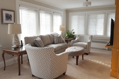 Small elegant enclosed carpeted and beige floor family room library photo in Other with beige walls and a media wall