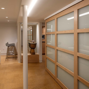 Diseño de sótano con ventanas retro, de tamaño medio, sin chimenea, con paredes blancas, suelo de corcho y suelo beige