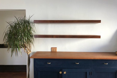 Example of a transitional dark wood floor and brown floor eat-in kitchen design in San Francisco with shaker cabinets, wood countertops, blue cabinets and brown countertops