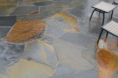 This is an example of a mid-sized eclectic full sun backyard stone outdoor basketball/tennis/multi-game court in Portland.