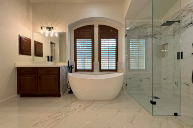 Large transitional master beige tile and porcelain tile porcelain tile, white floor and double-sink bathroom photo in Houston with shaker cabinets, dark wood cabinets, a vessel sink, quartz countertops, a hinged shower door, white countertops, a niche and a built-in vanity